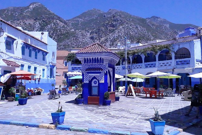Scenic view of Chefchaouen's blue-painted streets with traditional Moroccan architecture, part of a Fes and Chefchaouen sightseeing tour.
