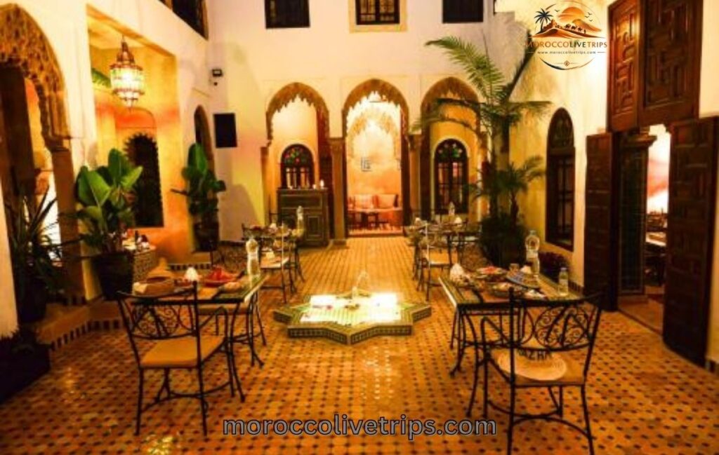 Moroccan host pouring mint tea for guests in traditional riad
Marrakech - Diyafa hospitality culture Morocco